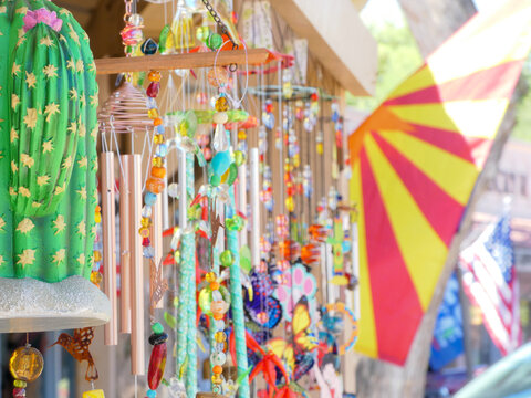 colorful mobiles, wind chimes, flags on display with blur effect