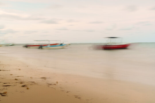 View of small boats anchored along the sandy beach in Las Terrenas, Samana Province, Dominican Republic.