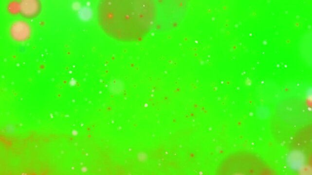 Floating particle bokeh overlay animation against bright green chroma key background for visual effects with screen background compositing video floating particles moving