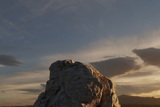 3d rendering of a rock spire in front of evening sky