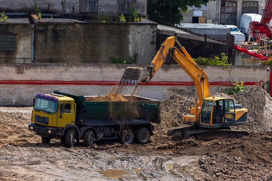 View of an excavator loading soil into a dump truck at a construction site in Vilnius, Vilnius County, Lithuania.