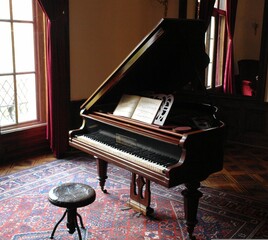 Vintage grand piano with sheet music in an elegant interior © Sergiu