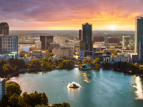 Orlando, Florida architecture in city downtown at sunset. USA travel destination. American urban landscape with Lake Eola Park and high-rise office buildings.