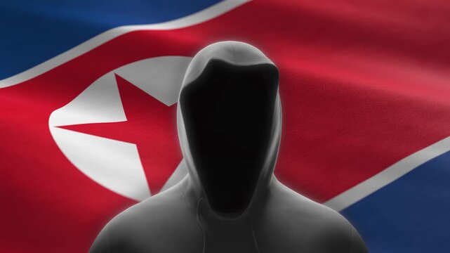 Hacker in a hoodie over North Korean flag - background loop