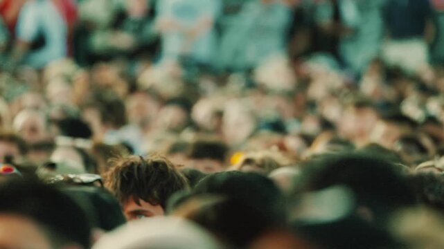 Crowd of diverse spectators watching soccer championship match, focused on enthusiastic fans with varying hairstyles and clothing in a vibrant outdoor stadium setting