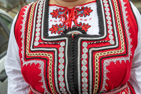 Woman in traditional clothing at a Kukeri festival in Bulgaria.