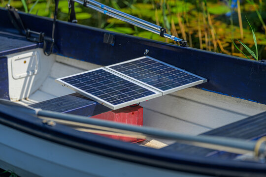 Portable solar panels installed inside small boat for energy.