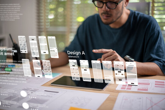 A male designer working on website prototype, in UX UI concept design and development for a website and mobile app prototype, with hologram interface