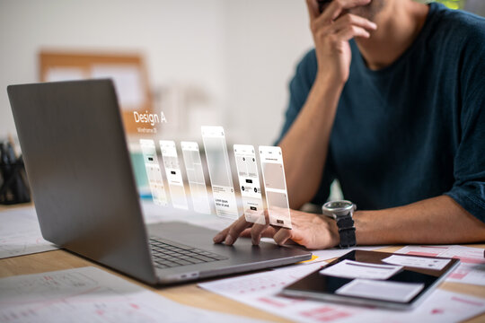 A male designer working on website prototype, in UX UI concept design and development for a website and mobile app prototype, with hologram interface