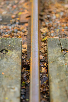 Close up of old railway track and weathered wooden sleepers.