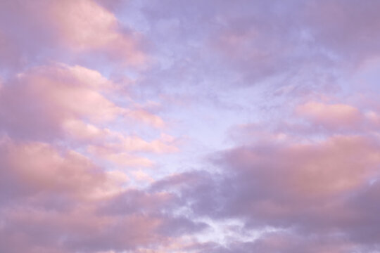 Pastel Pink Sunset Sky with Soft Fluffy Clouds Background
