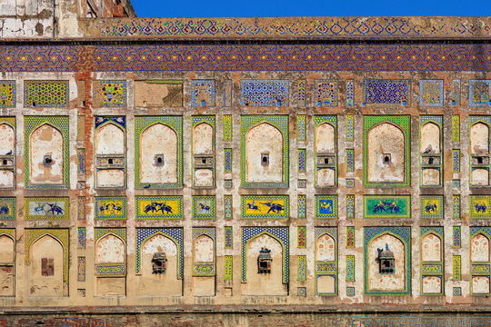 View of the Pictured Wall at Lahore Fort, featuring intricate Mughal-era tile work, geometric patterns, and vibrant frescoes in Lahore, Punjab, Pakistan.