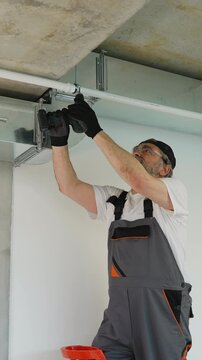 Professional installer assembling ventilation system ductwork