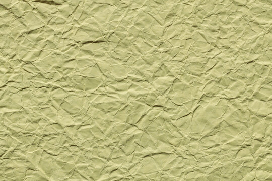 Crumpled olive green paper texture background with wrinkles for creative design