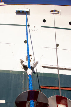 Lines with Rat Guards on a ship in a harbour