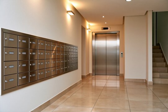 Modern Apartment Building Hallway with Mailboxes, Elevator, and Staircase