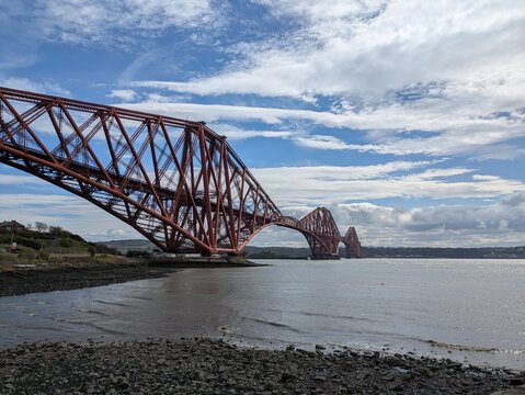 The Forth Bridge, a UNESCO World Heritage Site, is a famous cantilever railroad bridge in Scotland, connecting Edinburgh and Fife since 1890.