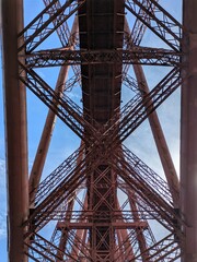 Fototapeta premium The Forth Bridge in Scotland, a UNESCO World Heritage Site, showcases stunning engineering and connects Edinburgh to Fife.