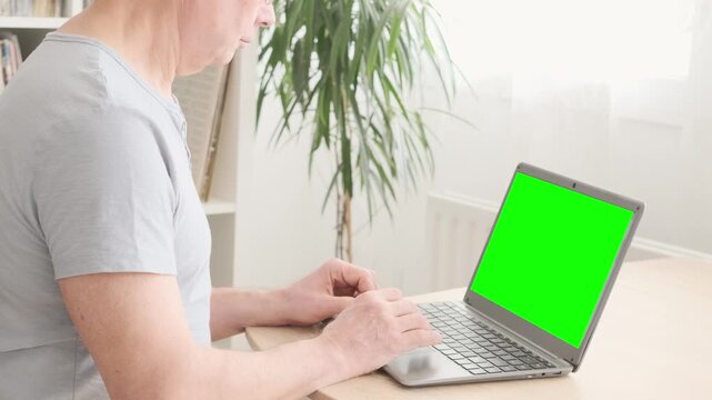 elderly man hesitantly uses laptop, green screen mockup, representing challenges and opportunities digital literacy for seniors, Technology and Aging, Learning New Skills