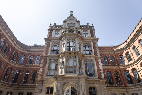 View of the historic red brick facade of the Newton Building at Nottingham Trent University with arched windows and stone detailing in Nottingham, England, United Kingdom.