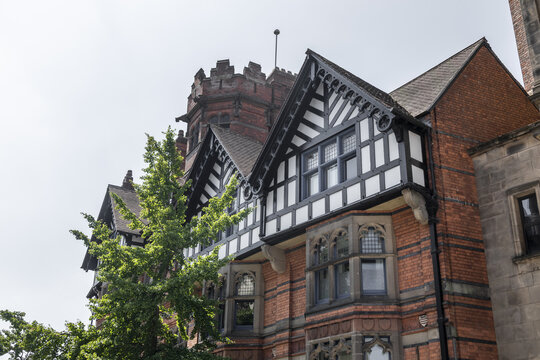 View of a historic timber-framed building with red brick walls, decorative gables, and stone window frames in Nottingham, England, United Kingdom.
