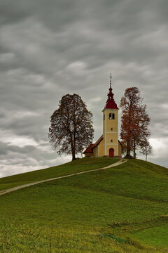 Undulating dirt trail going uphill to the Baroque, XVII c.Saint Thomas church (Cerkev svetega Tomaza) in Gorenji Vrsnik village. Idrija-Slovenia-196