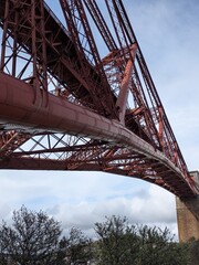 Fototapeta premium The Forth Bridge, a UNESCO World Heritage Site in Scotland, is a famous cantilever railway bridge opened in 1890, connecting Edinburgh to Fife.