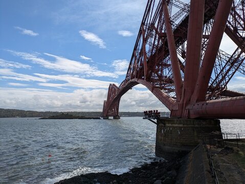 The Forth Bridge is a UNESCO World Heritage railway cantilever bridge in Scotland, connecting Edinburgh to Fife since 1890.