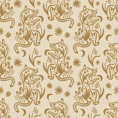 Fototapeta premium Artisanal seamless pattern displaying repeating ornamental wild tigers. This celestial grunge doodle background showcases antique big cats surrounded by mystical stars, crescent moons, and botanicals