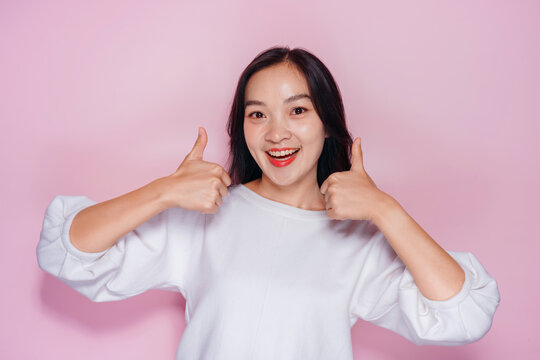 Asian Woman Smiling Giving Thumbs Up on Pink Background Happy Ch