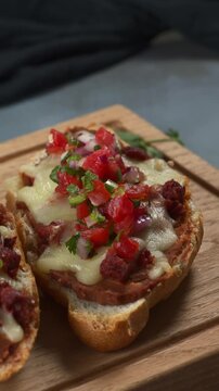 Mexican food, molletes made with bolillo bread, refried beans, cheese and spicy salsa