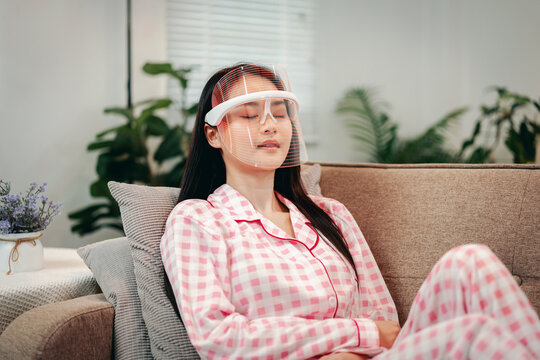 Longevity Lifestyle Woman Using LED Mask For Skincare At Home Re