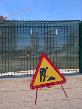 Construction warning sign near building site in Calpe Spain indicates ongoing development work