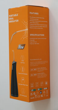 Norwich, United Kingdom &ndash; June 8, 2026: Everyday retail and consumer life Portable oral irrigator in bright orange packaging with specifications branding information