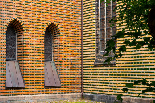 Historic Brick Church Wall with Decorative Pattern and Arched Windows