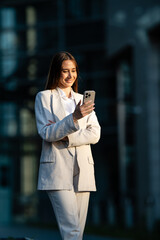 Fototapeta premium Businesswoman checking smartphone, communicating and networking online