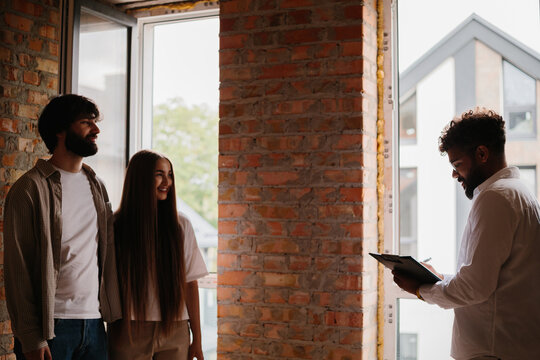 Real estate agent showing potential home to couple