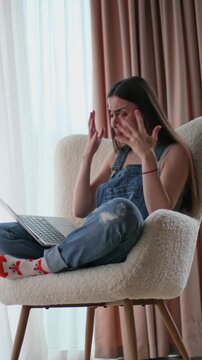 Frustrated woman closing laptop after computer problem