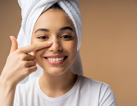 Beautiful Young Woman with Freckles in a White Towel Touching Her Skin