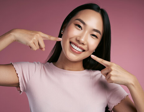Radiant Young Asian Woman Highlighting Her Healthy Teeth and Bright Smile