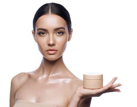 Beautiful Woman with Glowing Skin Holding a Peach Cosmetic Cream Jar