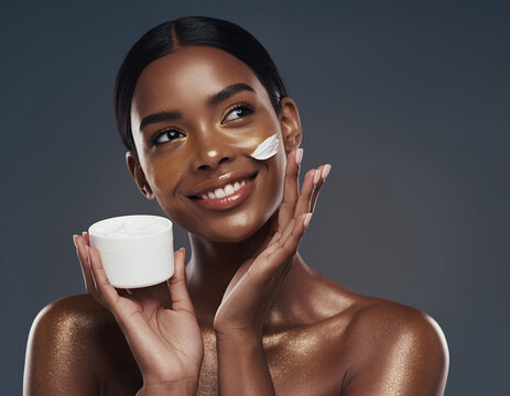 Radiant Black woman with golden shimmer skin holding luxury face cream jar