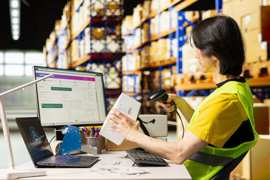 Asian warehouse worker scans air waybill labels beside an AI brain graphic, using tracking software and a handheld scanner to register barcode numbers for shipments and online orders.