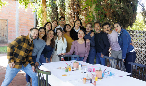 portrait of latin and multigenerational group of people or family together in a terrace outdoors in Mexico Latin america, diverse hispanic group of friends
