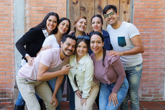 group of latin and multigenerational people or family together in a terrace outdoors in Mexico Latin america. Portrait of diverse hispanic group of friends