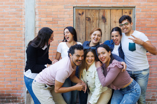 group of latin and multigenerational people or family together in a terrace outdoors in Mexico Latin america. Portrait of diverse hispanic group of friends