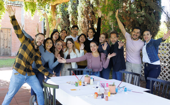 large group of latin people in painting classes in a terrace outdoors in Mexico Latin America, multi generational Hispanic and diverse team meeting in art classes 