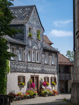Furth, Germany - 15 July 2026: View of a historic half-timbered house with slate cladding and colorful flower boxes in the old town.