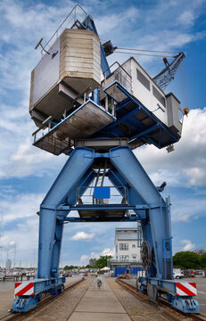 Large Blue Gantry Crane in Harbor with Rail Tracks and Industrial Setting