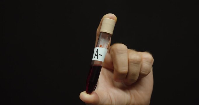 Close-up of a blood sample tube labeled for blood typing. Concept of blood group testing, laboratory diagnostics, healthcare, and medical analysis.